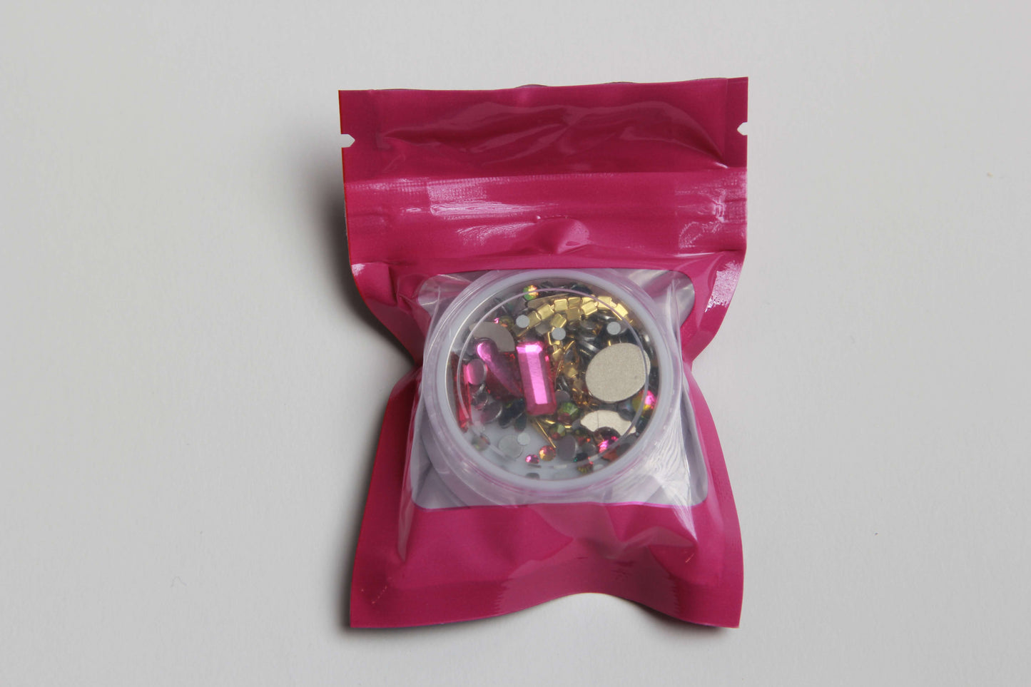 Add a touch of glam to your nails with our stunning Blaque D' Youre pink and gold rhinestone nail charms! Our high-quality rhinestones are perfect for creating a dazzling and unique nail art design. Whether you're going for a subtle accent nail or an all-out blinged-out look, our pink and gold rhinestone nail art will make your nails stand out from the crowd. Shop now and get ready to elevate your manicure game!