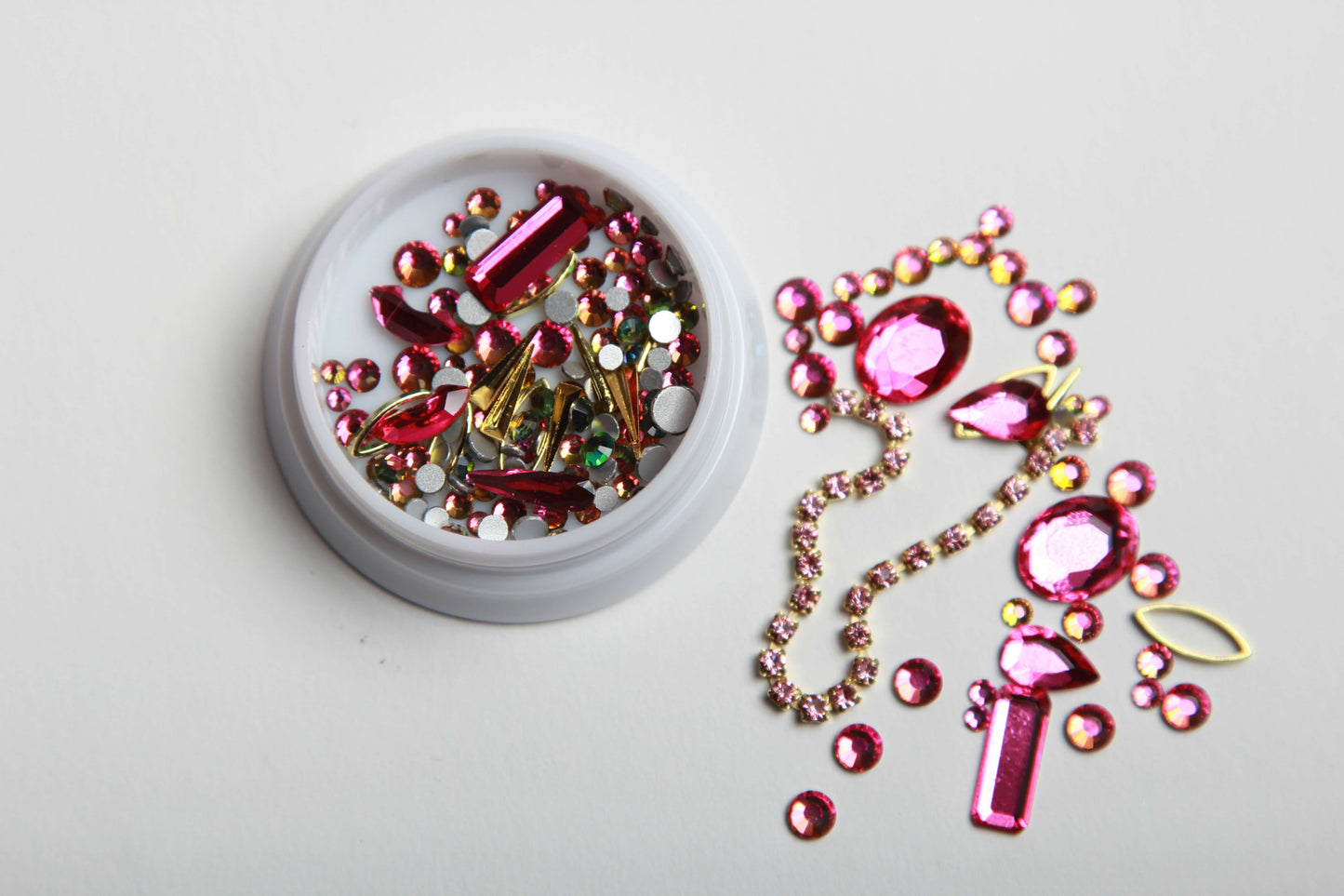 Add a touch of glam to your nails with our stunning Blaque D' Youre pink and gold rhinestone nail charms! Our high-quality rhinestones are perfect for creating a dazzling and unique nail art design. Whether you're going for a subtle accent nail or an all-out blinged-out look, our pink and gold rhinestone nail art will make your nails stand out from the crowd. Shop now and get ready to elevate your manicure game!